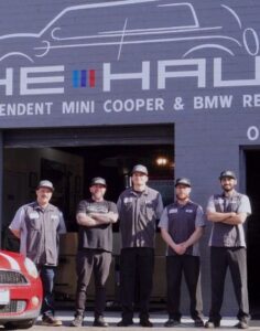 The Haus Auto BMW and MINI Cooper repair team standing outside the Los Angeles shop, expert European car mechanics